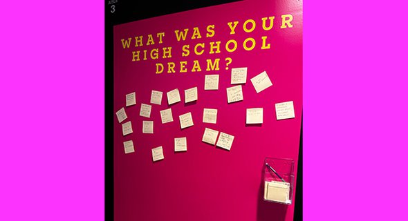 Audience engagement prompt in the Newhouse lobby ("What was your high school dream?")
